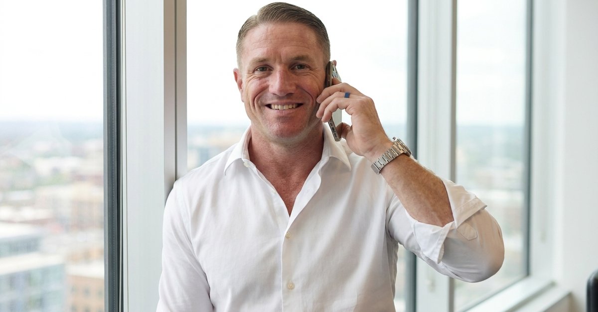J. Michael on a warm phone call by an office window